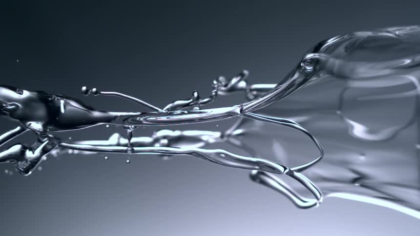 Water flies through the air against a gray background
