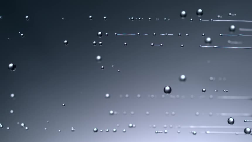 Water drops dripping horizontally from right to left