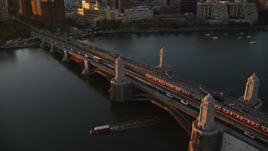 Setting sun shines across busy bridge near downtown