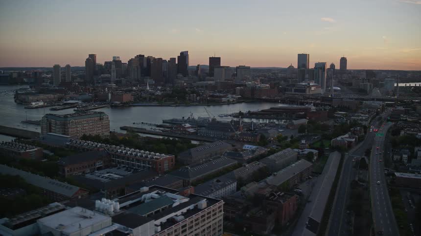 Aerial panorama of a coastal city with the sunrise sun