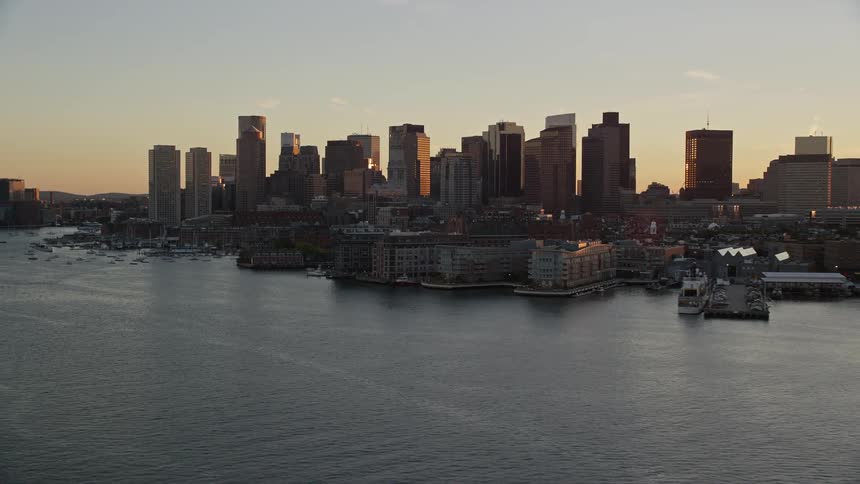 Downtown skyline borders waterfront against a red tinted horizon