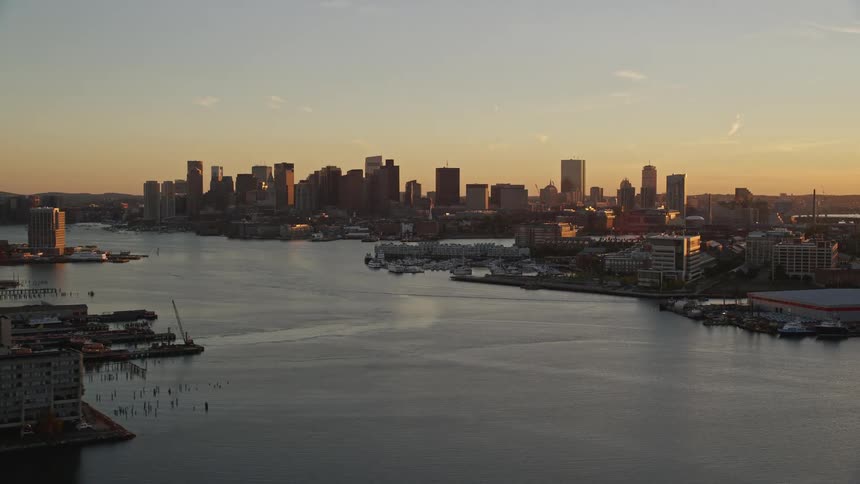Aerial panorama of a coastal city at dawn