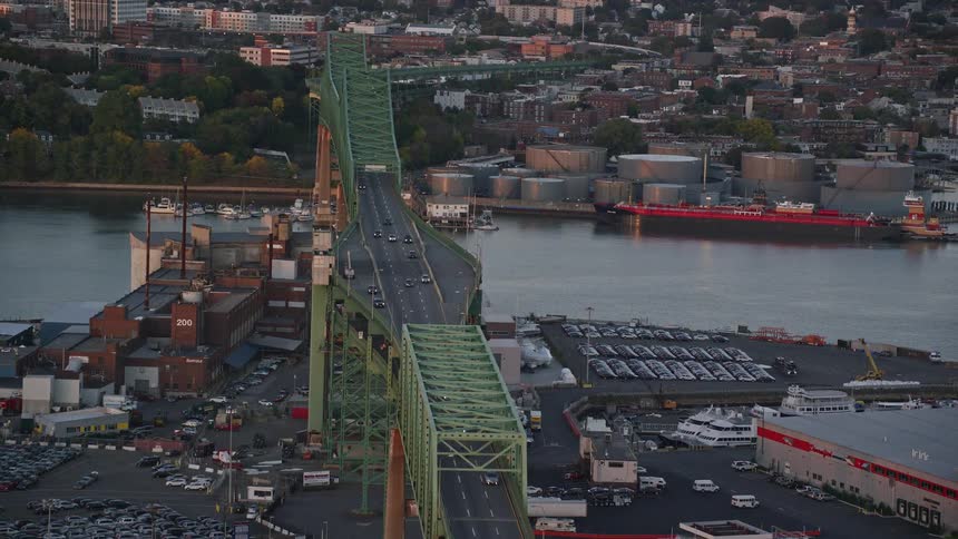 Aerial panorama of a seaside port with a central bridge and vehicles moving