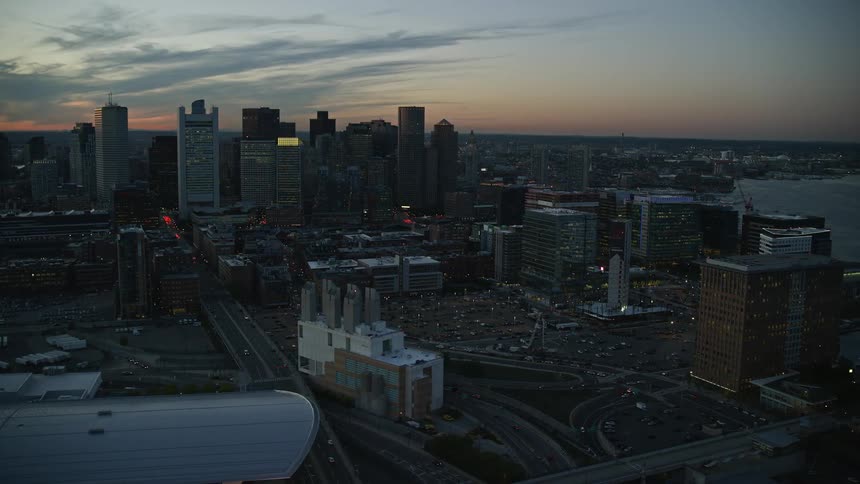 City skyline with busy highway at dusk