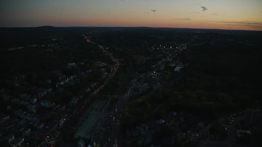 Aerial view of a busy highway in a neighborhood at dusk