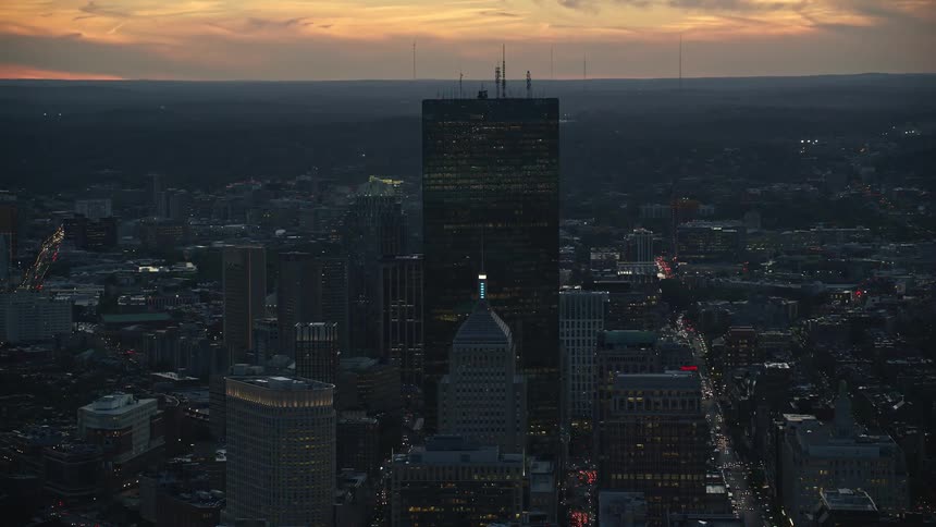 Aerial view of a metropolis with skyscrapers under an evening sky
