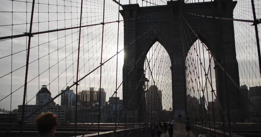 People walking on a metropolitan city bridge