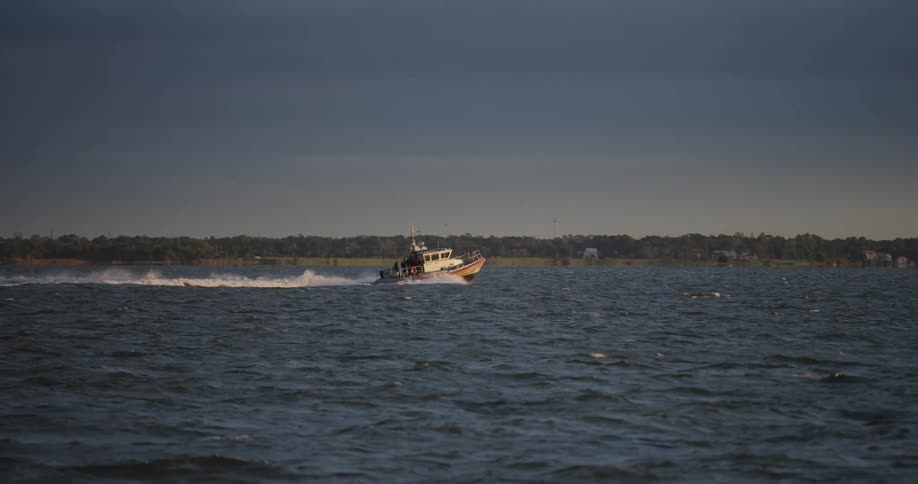 A boat cruises in the wide open ocean