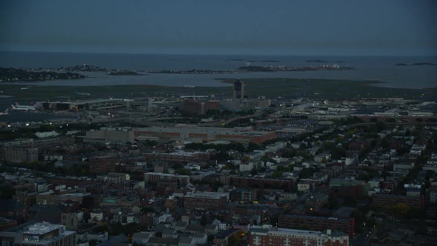 Panorama of a city by the sea in a dark dawn sky