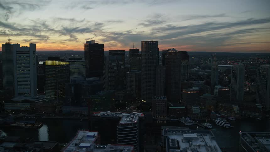 Aerial panorama of a metropolis with seaside skyscrapers and the late afternoon sun
