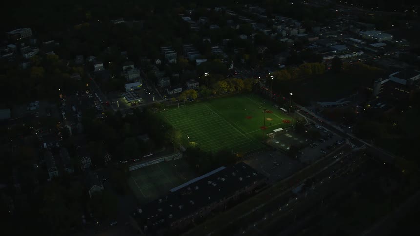 Aerial view of a sports arena in a small town at night