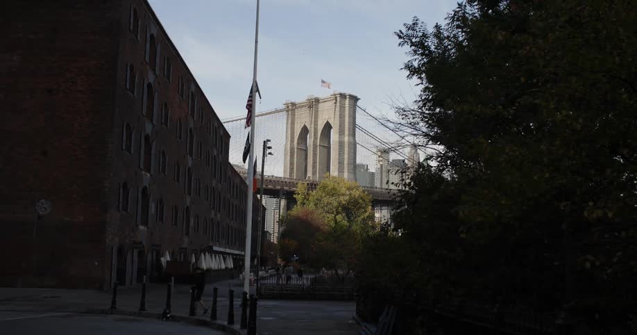 A historical brick building sits next to a drawbridge in a city