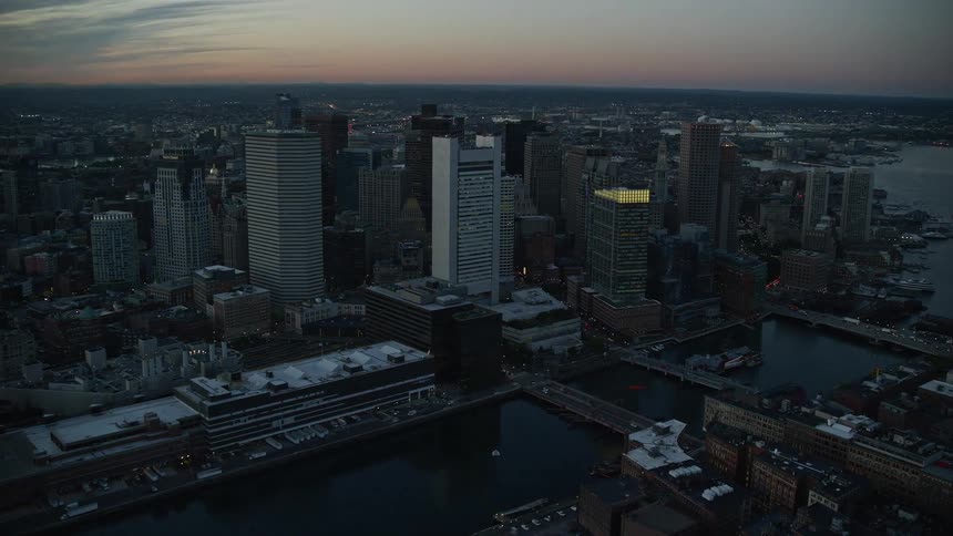 Aerial panorama of a metropolis by the edge of a lake in a dawn sky