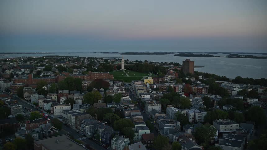 Aerial view of coastal city and highways at dusk
