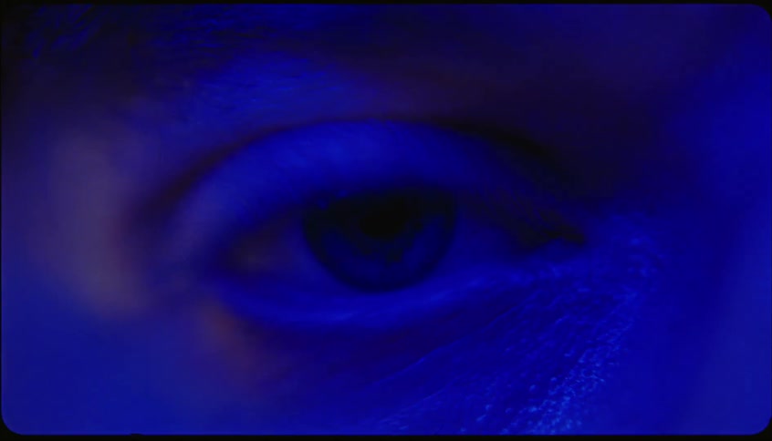 Portrait of a womans eye with blue and pink lights
