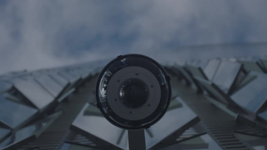 Clouds pass over skyscraper with an outdoor camera