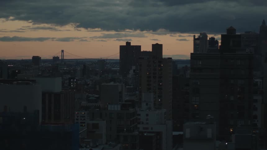 Panorama of a city seen from inside a building with a dawn sky