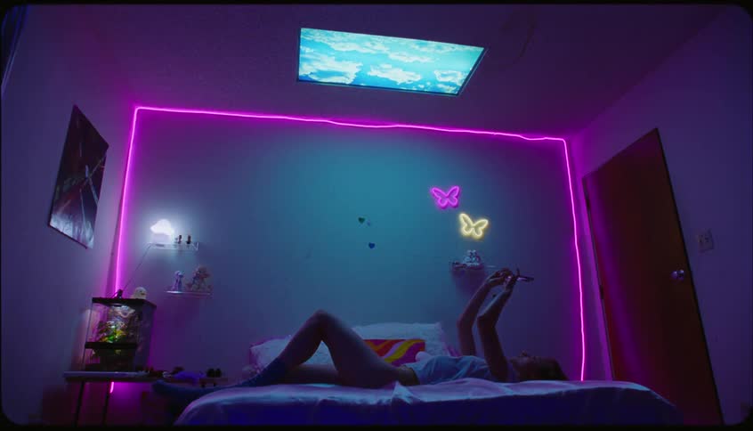 Lady take selfies while laying on her back on the bed indoor