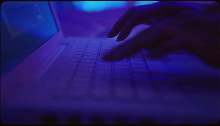 Closeup of a persons hands typing on the notebook keyboard
