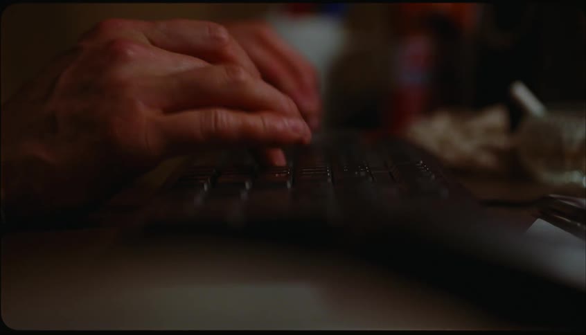 Hands of a person typing on a keyboard and using the mouse