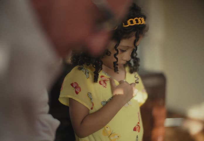Young child enters the room looking dull to see her father she then walks out