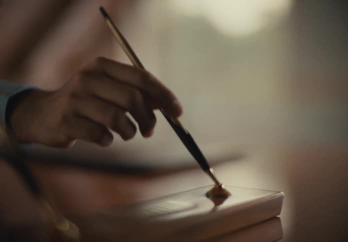 Person took a golden pen from its stand