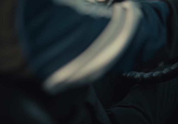Son sitting in the back seat of the car with a sad expression and his father at the wheel looking in the rearview mirror