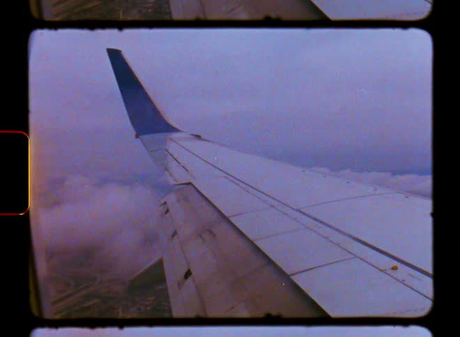 View of the wing of an airplane flying through the sky