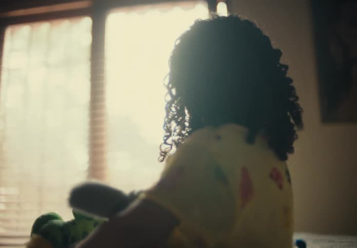 Girl plays with stuffed toys in bedroom