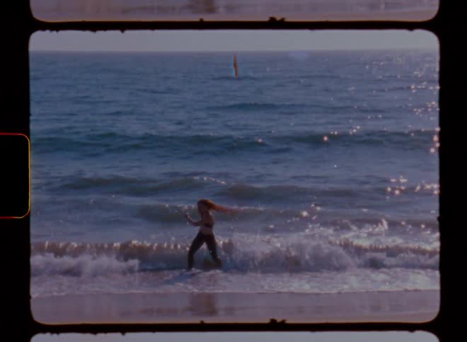 Woman playing at the waters edge on the beach