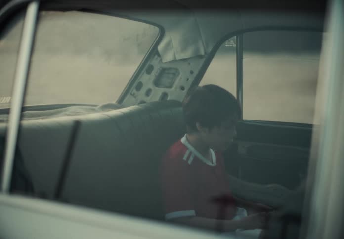A child gets into the back of the car