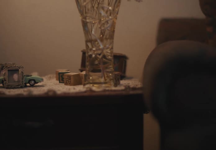 Child jumping on the sofa and causing an impact on the nearby sideboard with a swinging glass vase