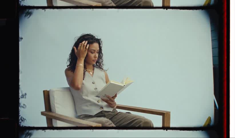 Woman sitting in an armchair reading a book