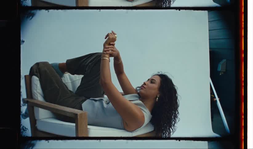 A woman is modeling on a chair