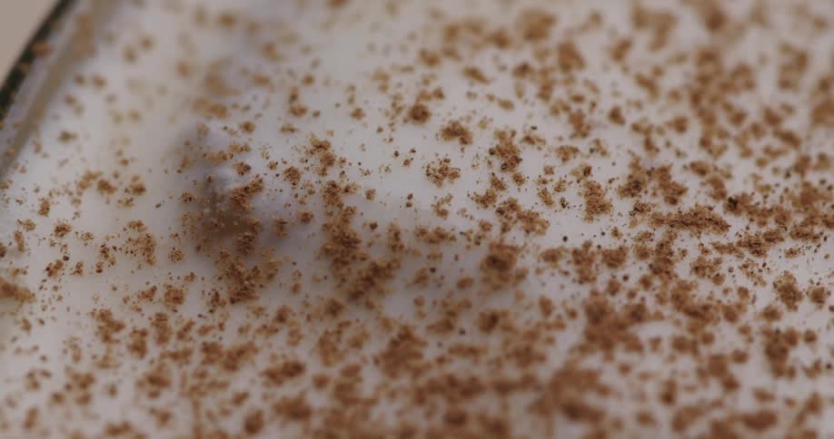 Several particles of a sandy element on top of a circular glass