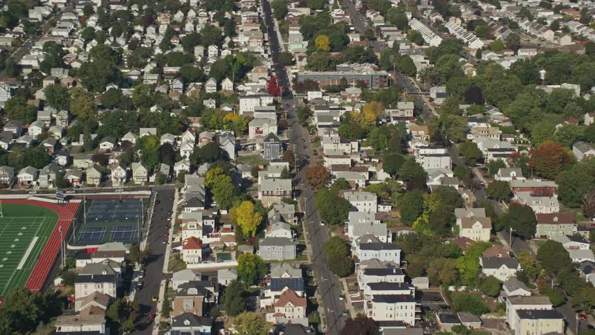 Aerial of a neighborhood with modern houses and a green area