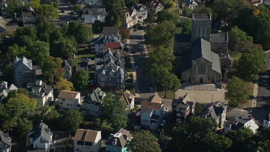A residential area with many trees amidst houses with old architecture