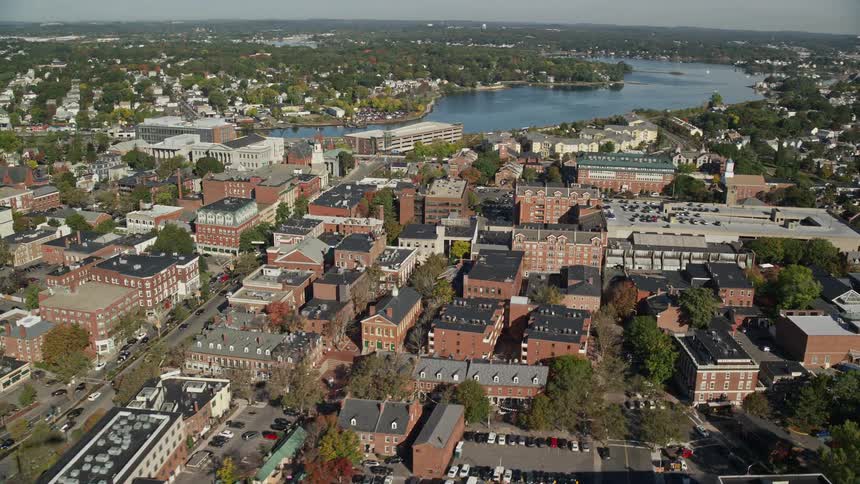 An aerial panorama of a city by the edge of a lake