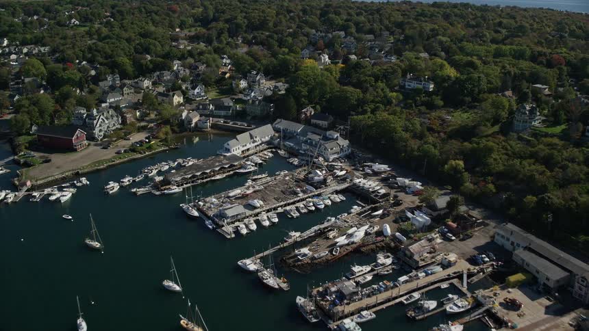 Docked boats and buildings in a suburban area at midday