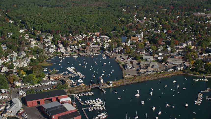Aerial of buildings waterways trees in a suburban area at midday