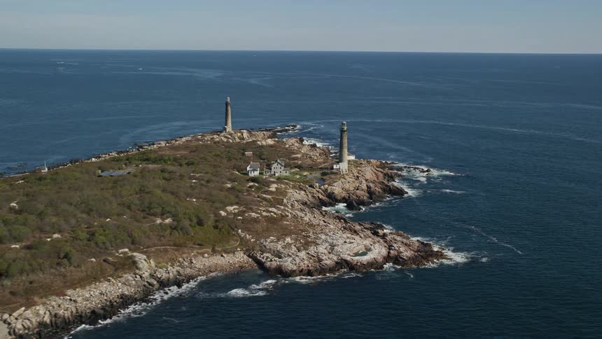 Two towers and isolated buildings on a small island at midday