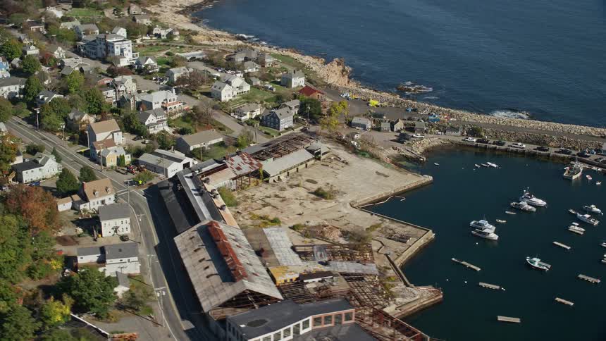 A residential area on the seafront with a small bay and some boats