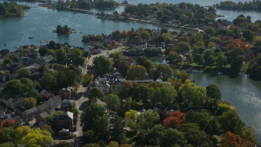 An aerial panorama of an urban city by the seaside with green areas