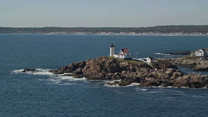 Aerial panorama of houses on a small rocky island with a seaside fort