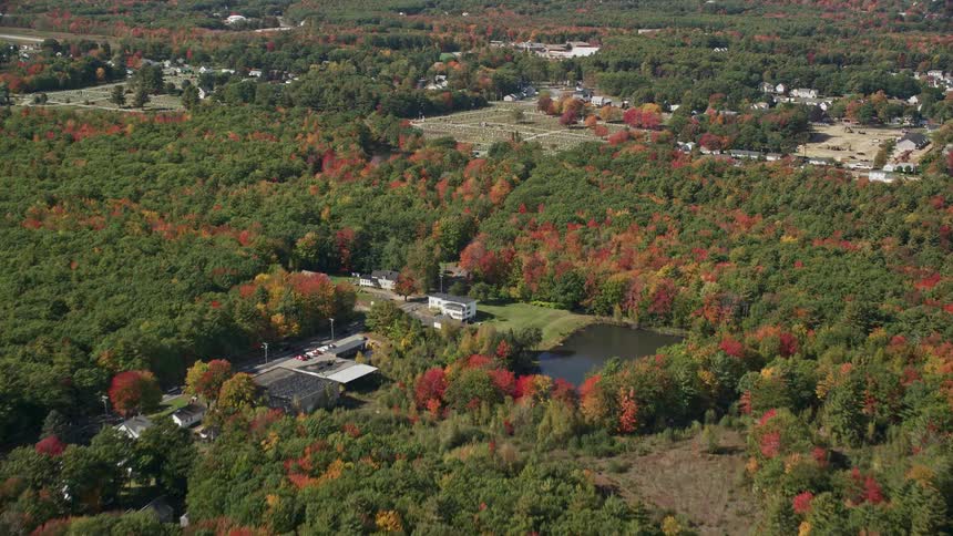 A sub urban area covered with trees as buildings are seen