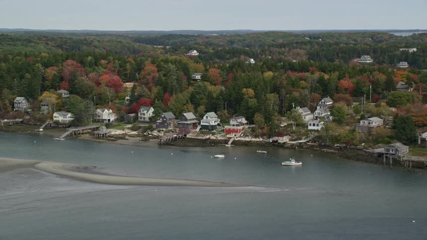 An aerial panorama of houses by the seaside amidst islands