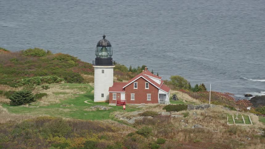 Aerial view of a house next to a fort on a coastal peak