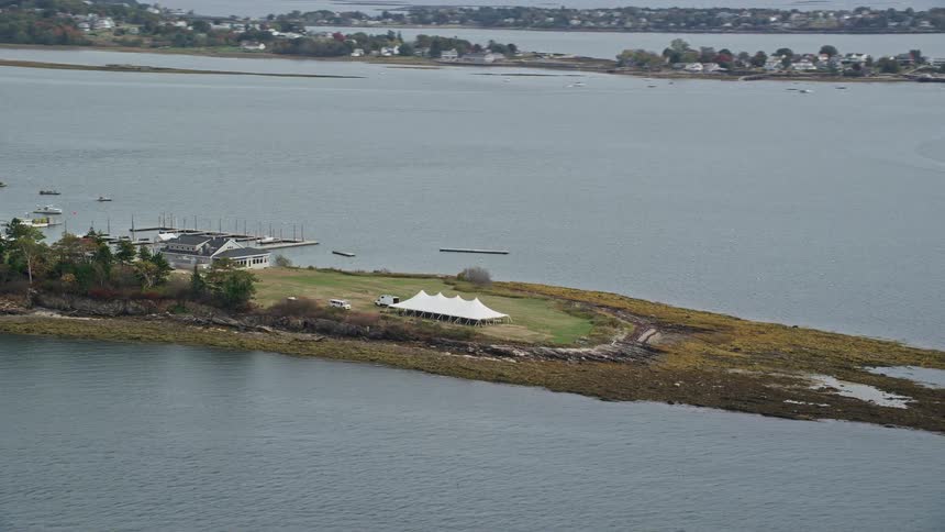 Aerial view a tent next to a pier in a lake