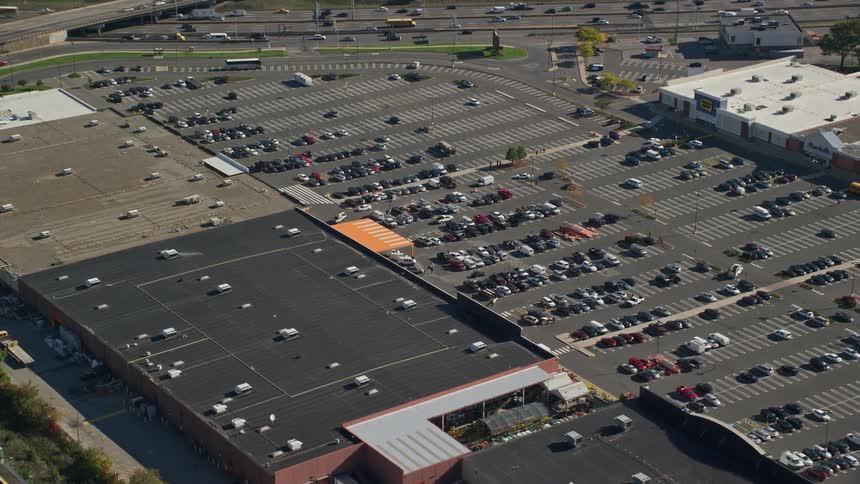An aerial panorama of a parking lot with multiple cars parked