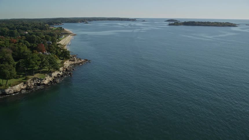 Aerial of coastal rural town with islands in the ocean